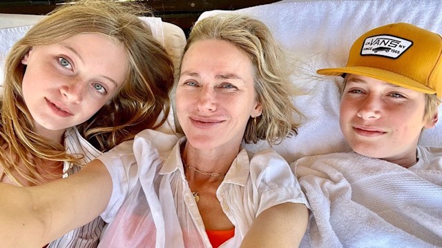 Kai, Naomi Watts and Sasha take a selfie while lying on a sofa