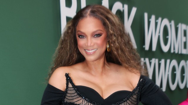 Tyra Banks posing in black dress at ESSENCE Awards