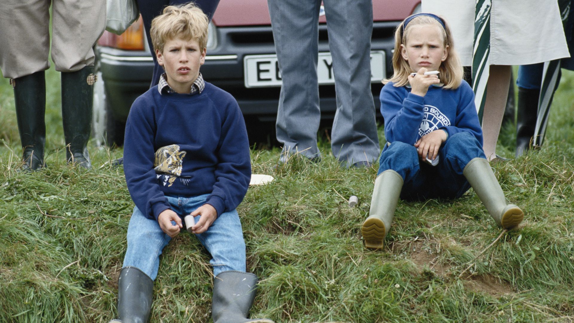 zara and peter sitting on grassy bank in 1988