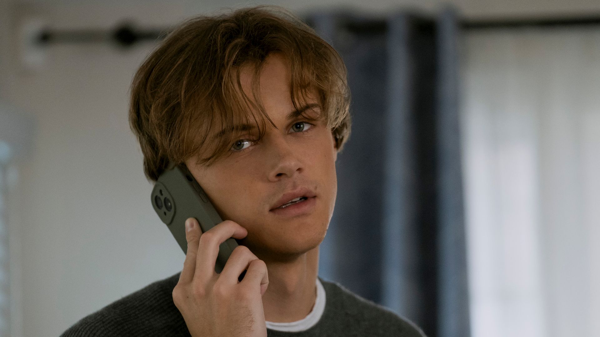 close-up of young man talking on phone