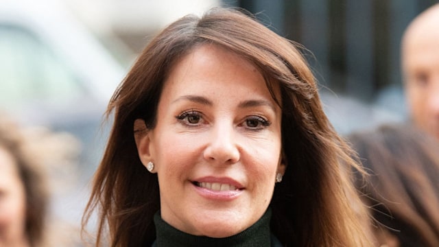 princess marie in green coat carrying flowers
