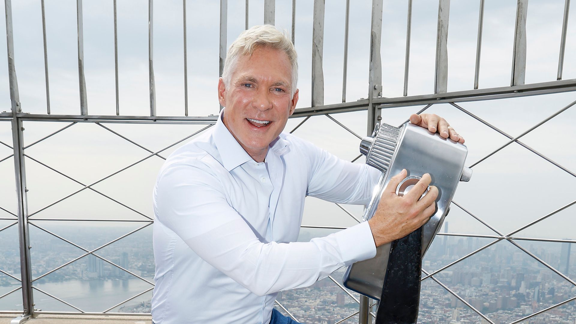 Sam Champion holding a camera on the Empire State Building