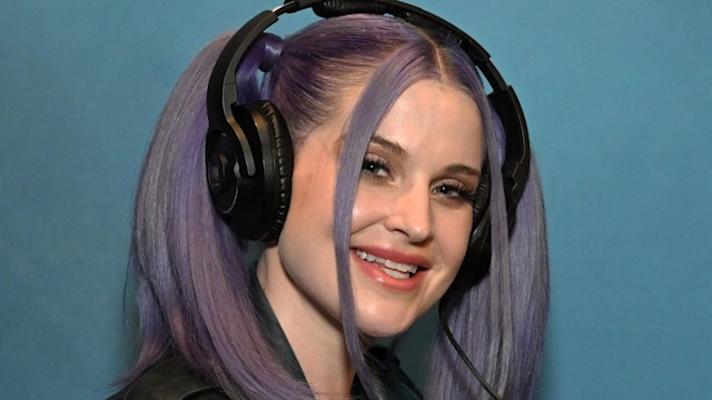 Kelly Osbourne in leather jacket and headphones