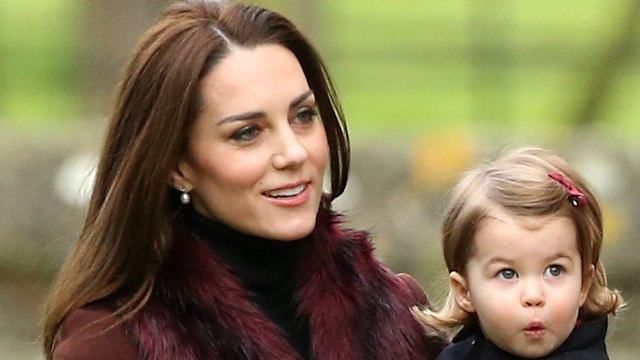 Catherine holding Princess Charlotte in coats