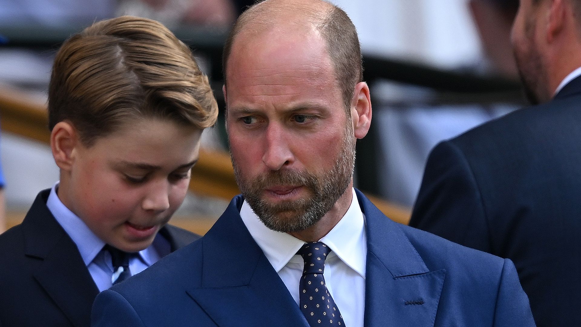 Prince William biting his lip in a blue blazer