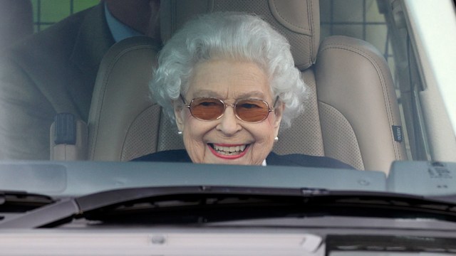 the queen smiling in car