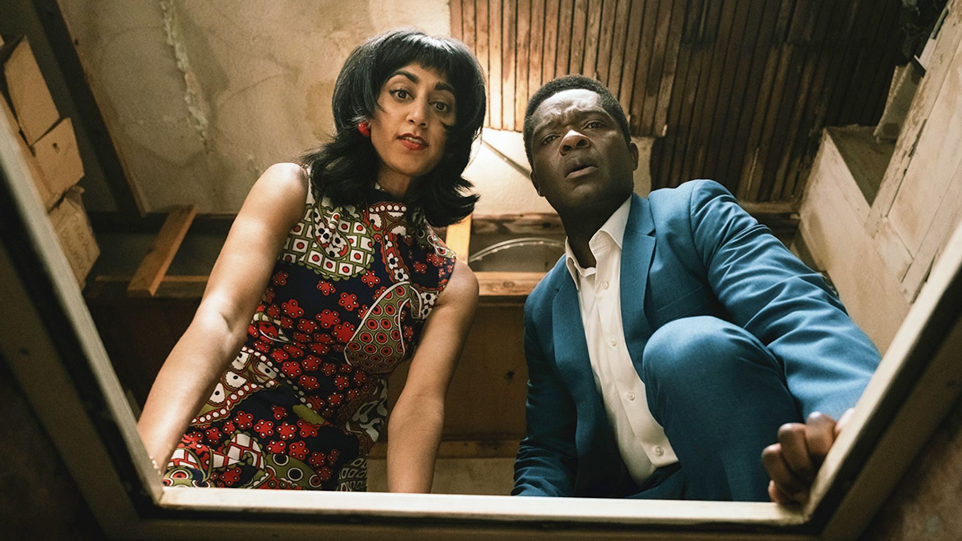 woman and man looking down into hole in floor 