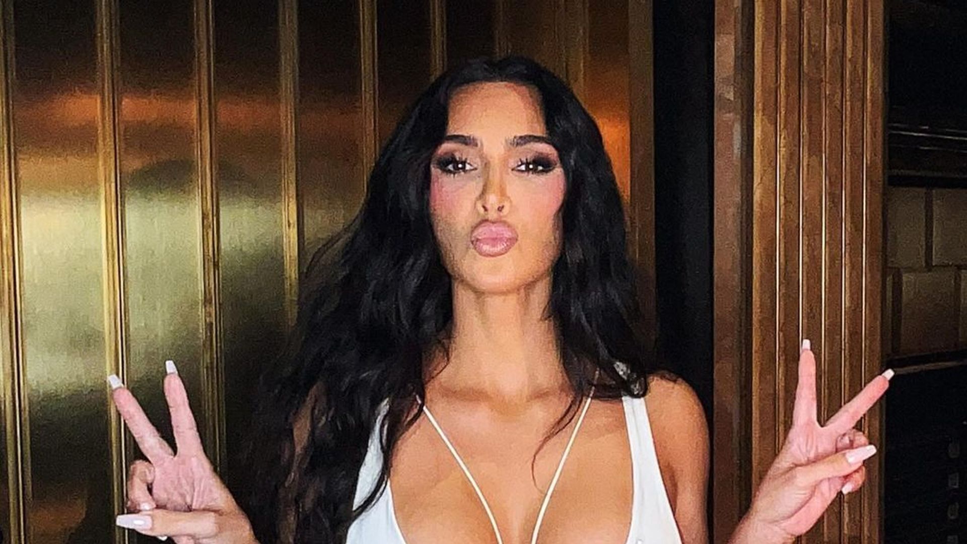 Kim Kardashian showcases her incredibly slim waist in daring white cut out dress in latest appearance
