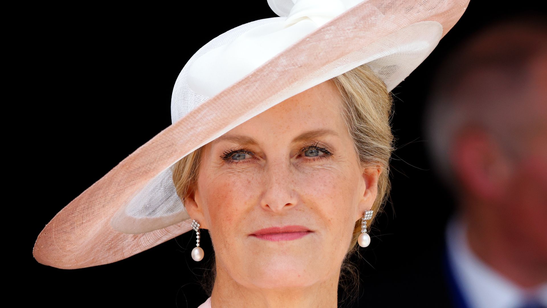 Sophie, Duchess of Edinburgh in pale pink hat and wrap dress shoulders up