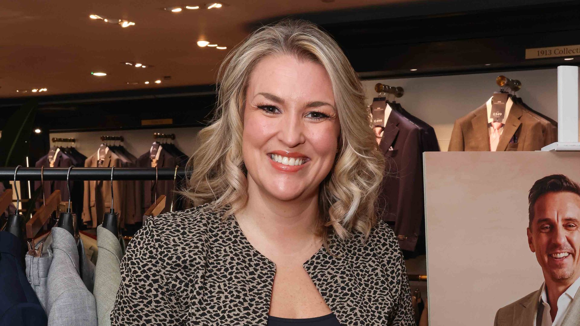 Sara Davies in a leopard print jacket smiling for the camera