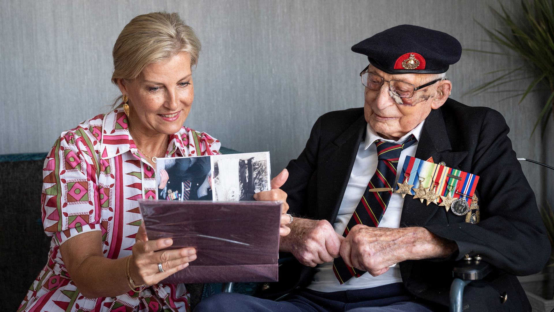Sophie, Duchess of Edinburgh, patron of the Java Far East Prisoner of War Club 1942, views photographs with 105-year-old Royal Marines veteran James 'Jim' Wren