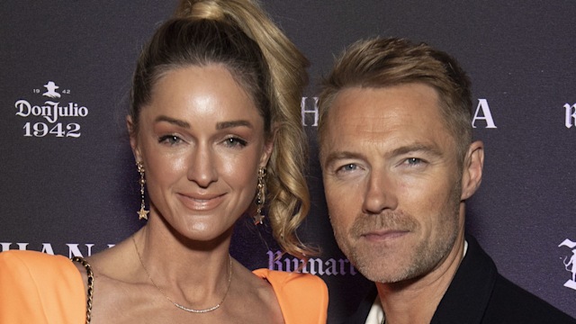 Storm Keating and Ronan Keating pose on red carpet at Bacchanalia's Grand Opening Party 