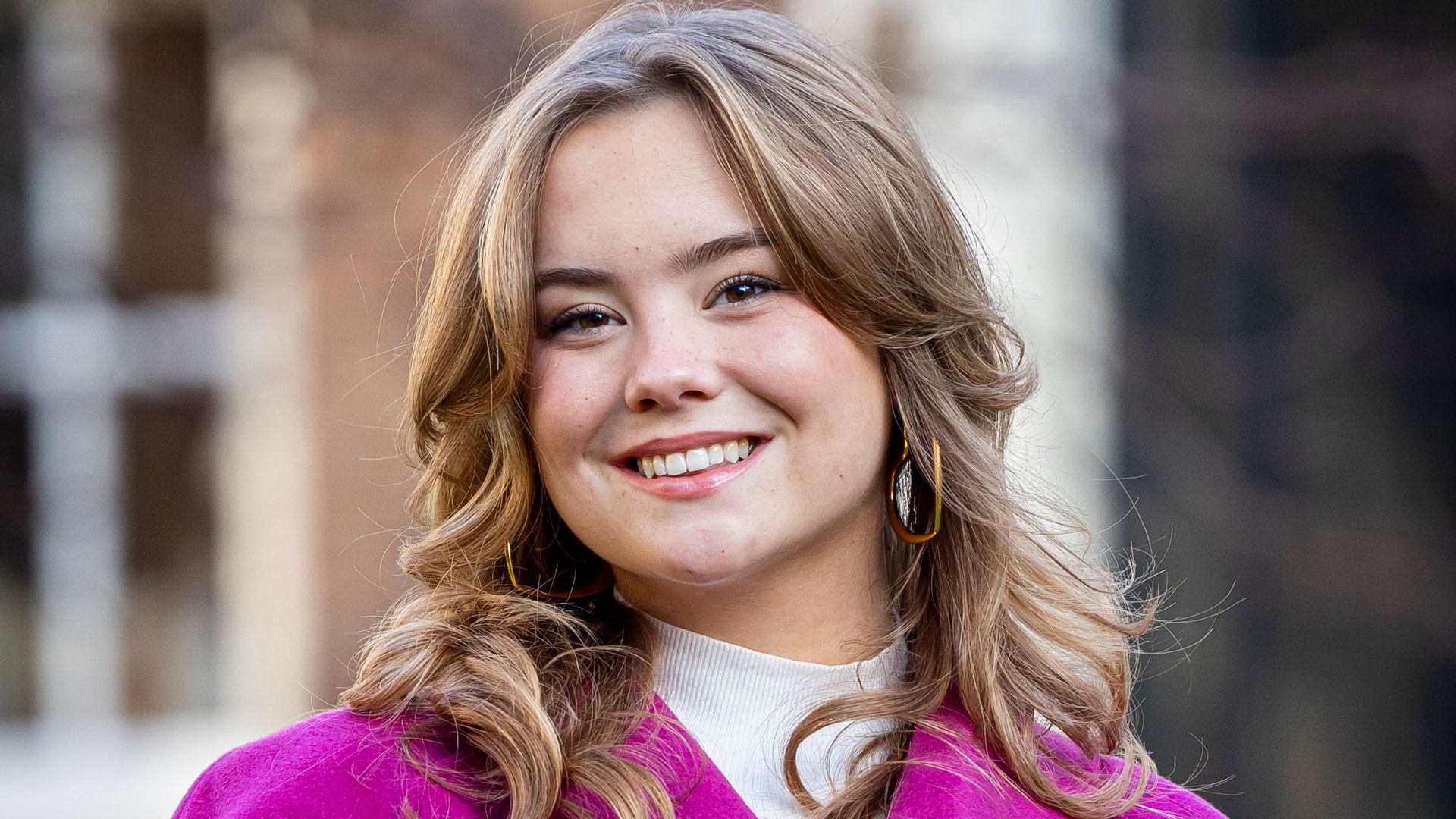Princess Ariane smiling in purple coat