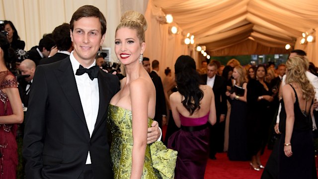 Ivanka wears a metallic green strapless gown with a dramatic train. Her hair is in an updo, and she's paired with her husband in a tuxedo on the red carpet.