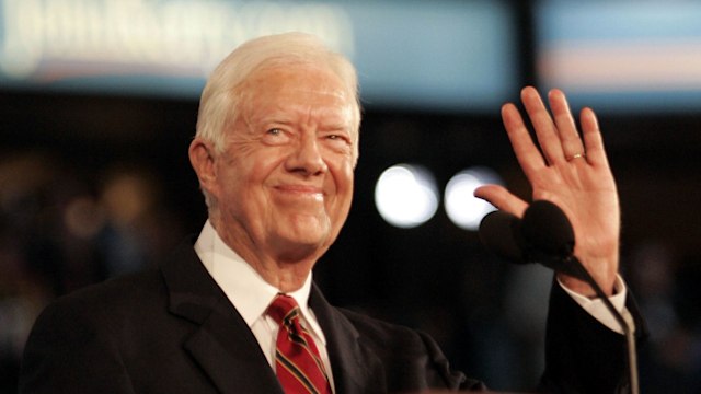 Former President Jimmy Carter acknowledges applause during the first day of the Democratic National Convention in Boston, Massachusetts Monday July 26, 2004