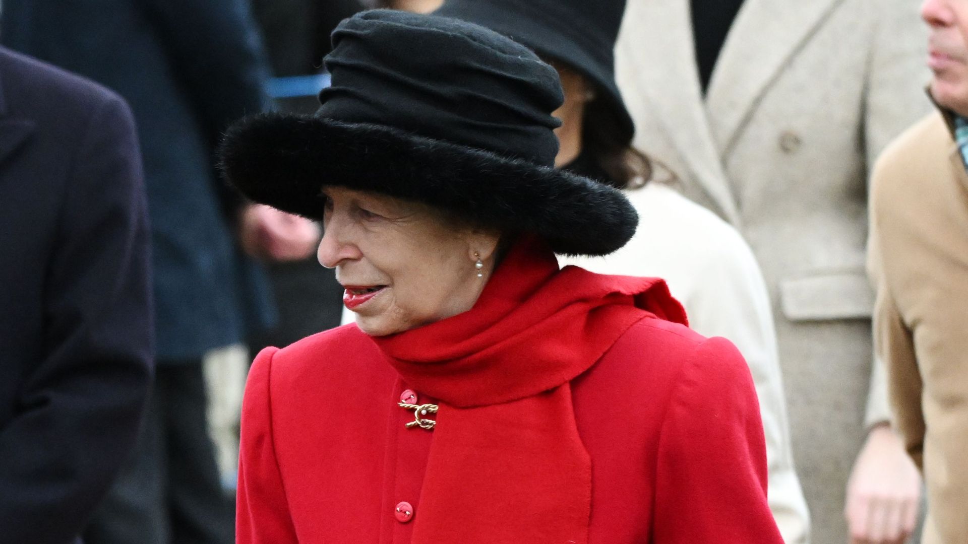 Princess Anne is the epitome of Christmas in red coat and tartan skirt