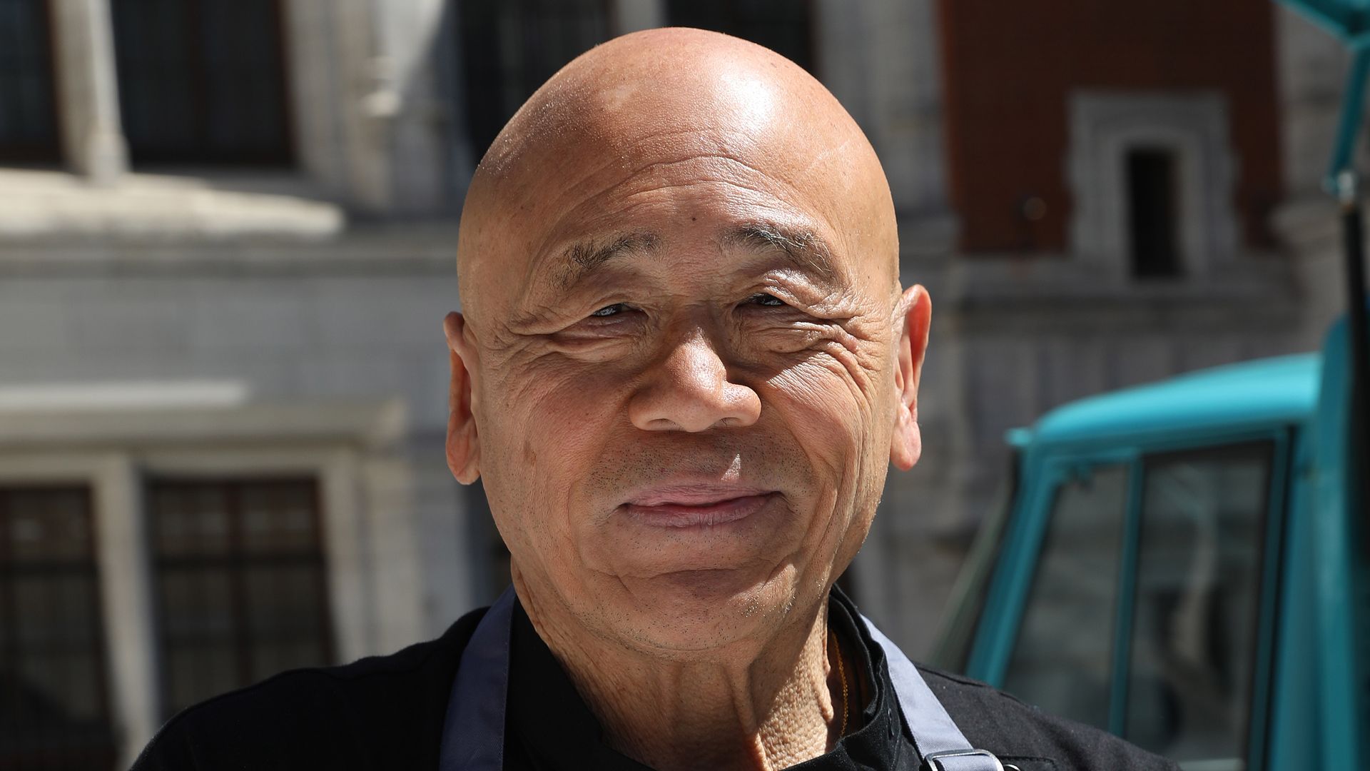 Chef Ken Hom smiling in an apron