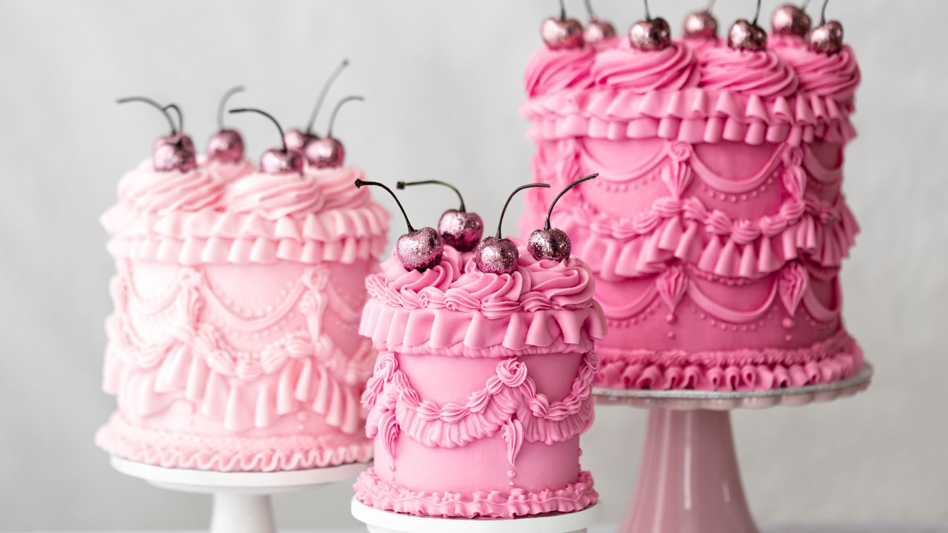 Three pink vintage style celebration cakes