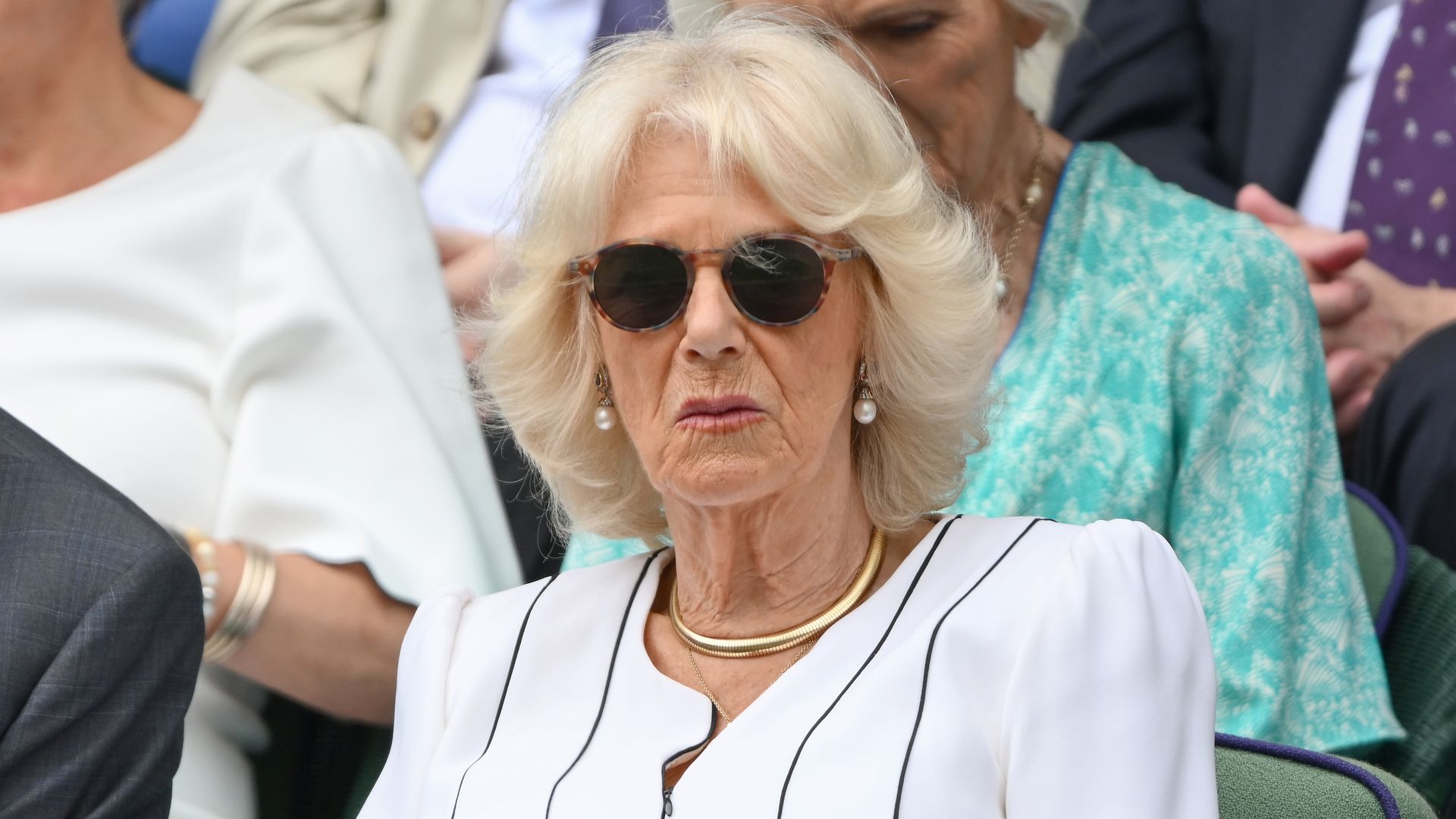 Queen Camilla in a white dress and sunglasses at Wimbledon