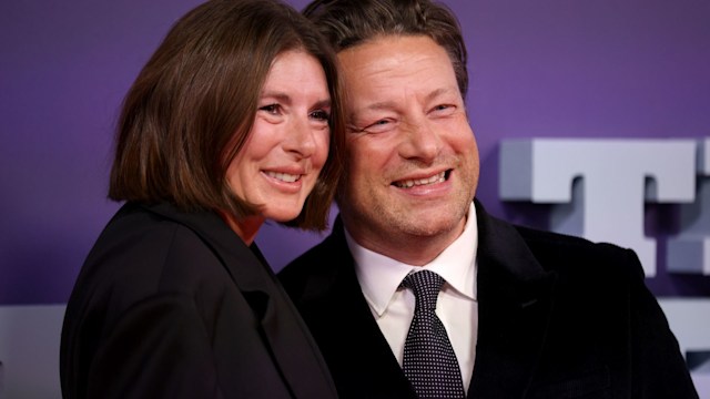 Jamie and Jools Oliver smiling on the red carpet