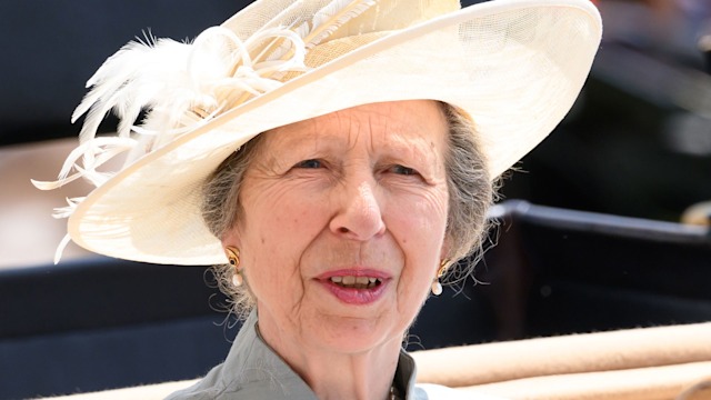 Princess Anne in a blue jacket and cream hat