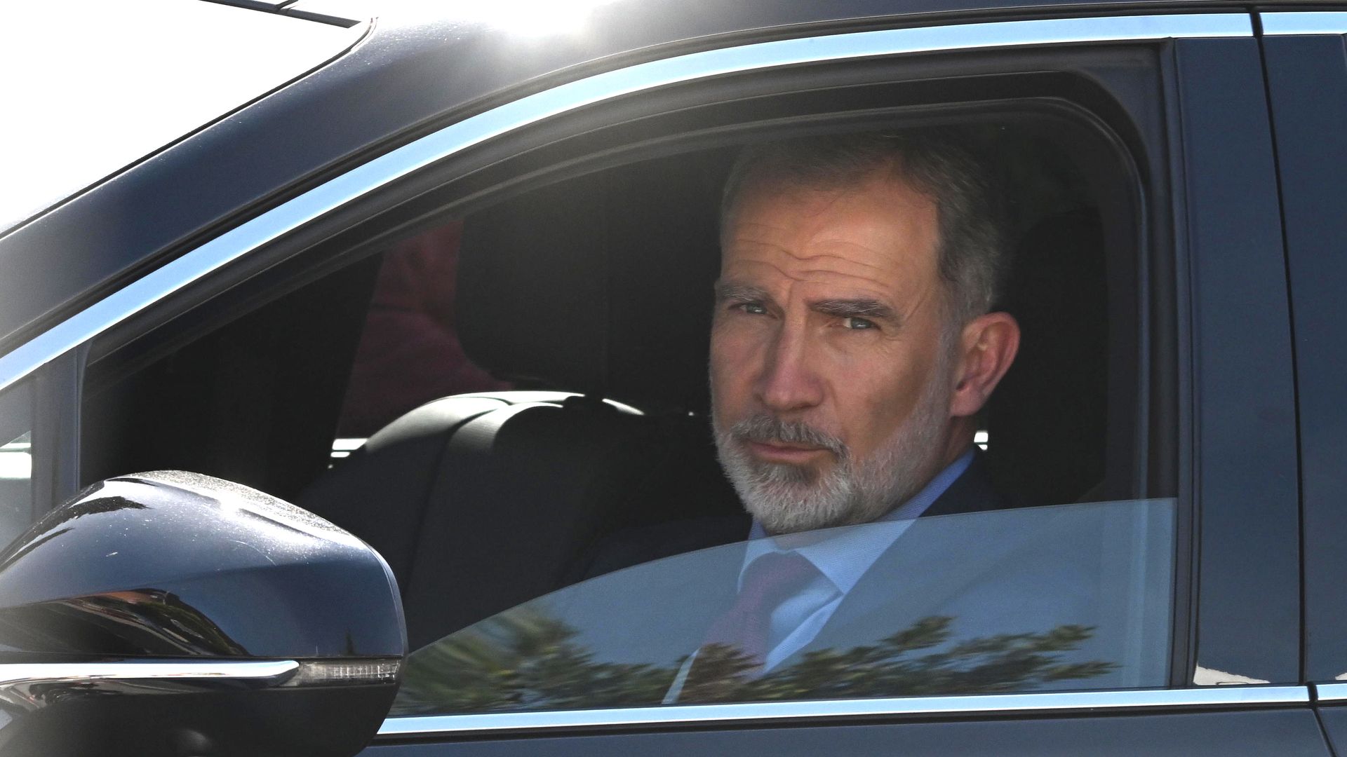 King Felipe drives from Ruber Clinic after visiting Queen Sofia