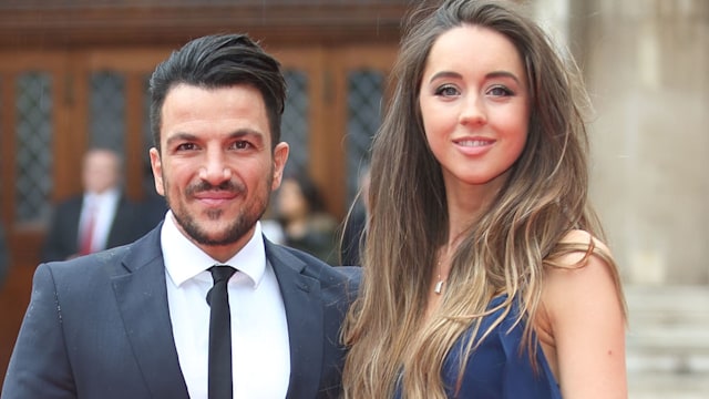 Emily Andre in a blue dress with Peter Andre in a suit on the red carpet