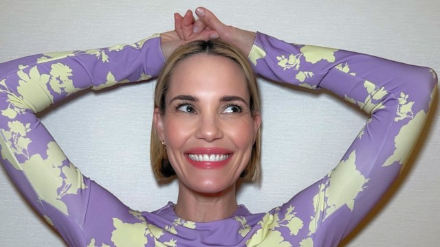 Actress Leslie Bibb from The White Lotus wearing a purple body con dress