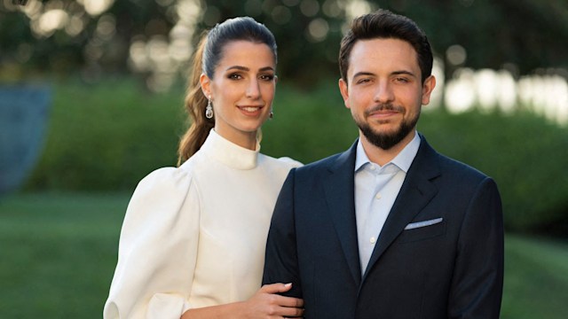 Crown Prince Hussein and Princess Rajwa in white smiling