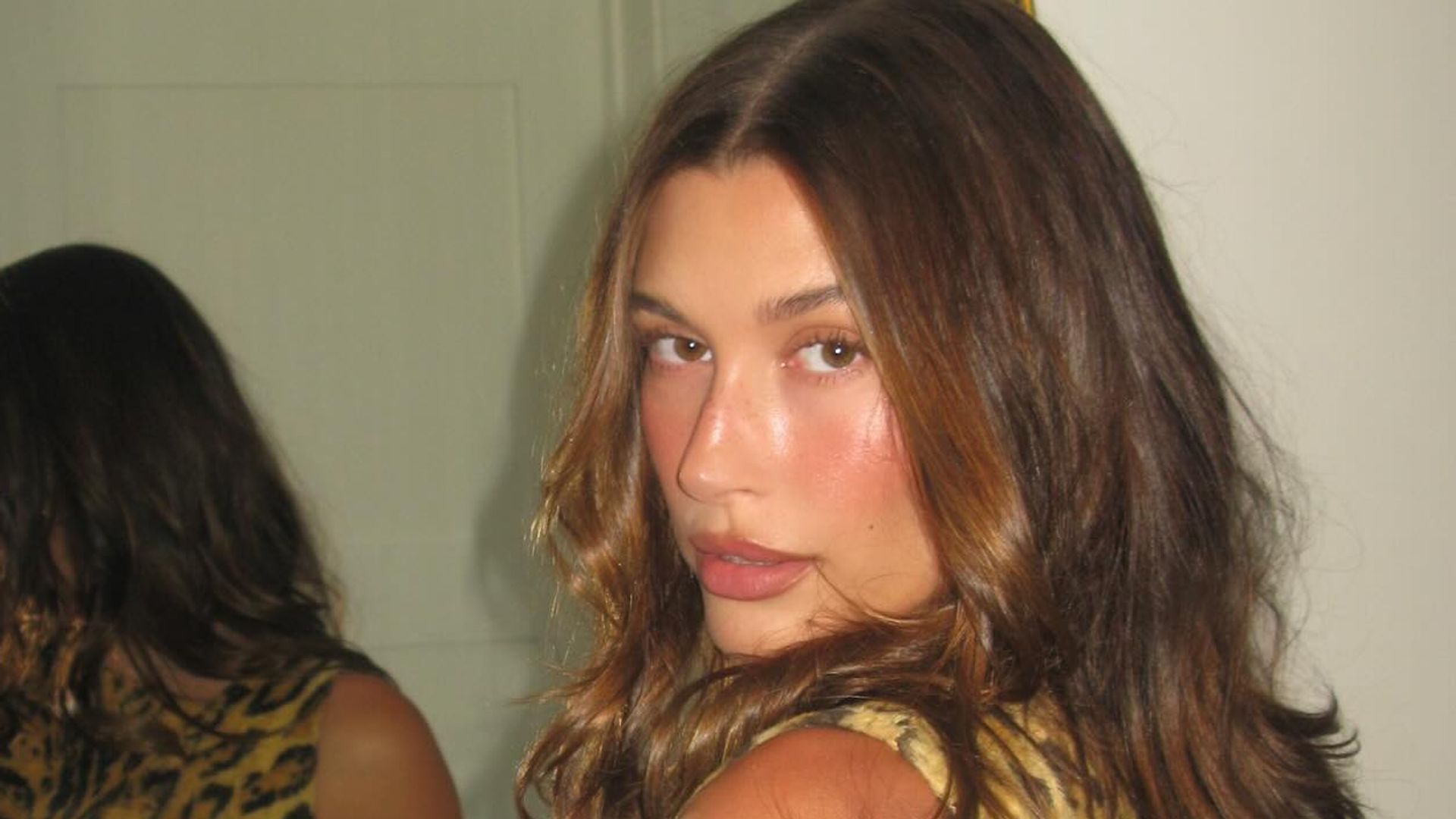 Hailey Bieber poses in an animal print mini dress on her instagram