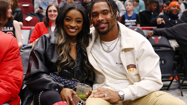 Simone Biles and Jonathan Owens pose for a photo during the first half between the Chicago Bulls and the Minnesota Timberwolves at the United Center on November 07, 2024 in Chicago, Illinois.