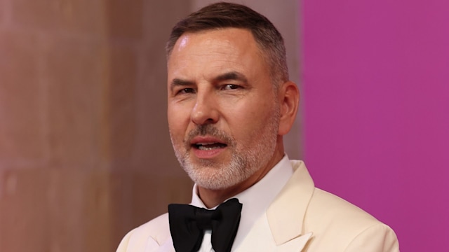 man standing in white suit with black bowtie