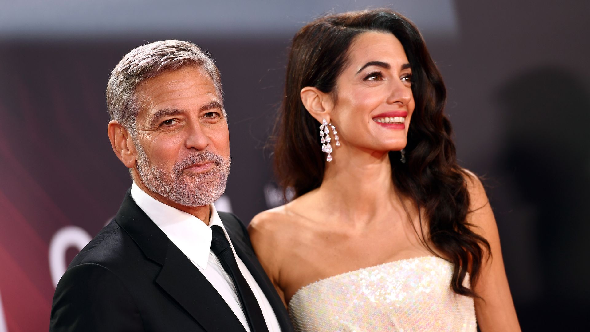 Amal Clooney stuns in sparkly frock during romantic date night with George in Lake Como