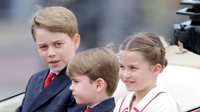 three children riding in carriage