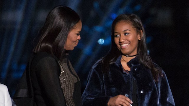 Michelle Obama looking at daughter Sasha smiling