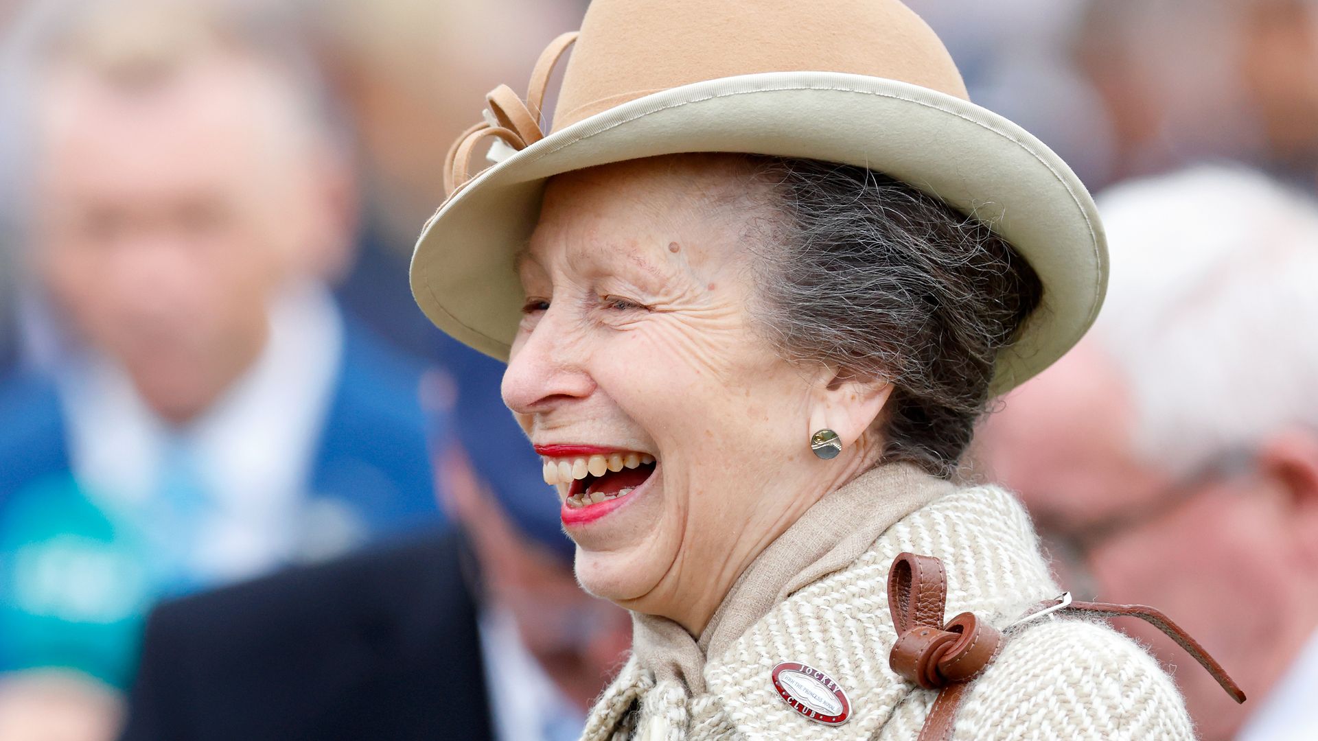 Princess Anne laughing in a hat