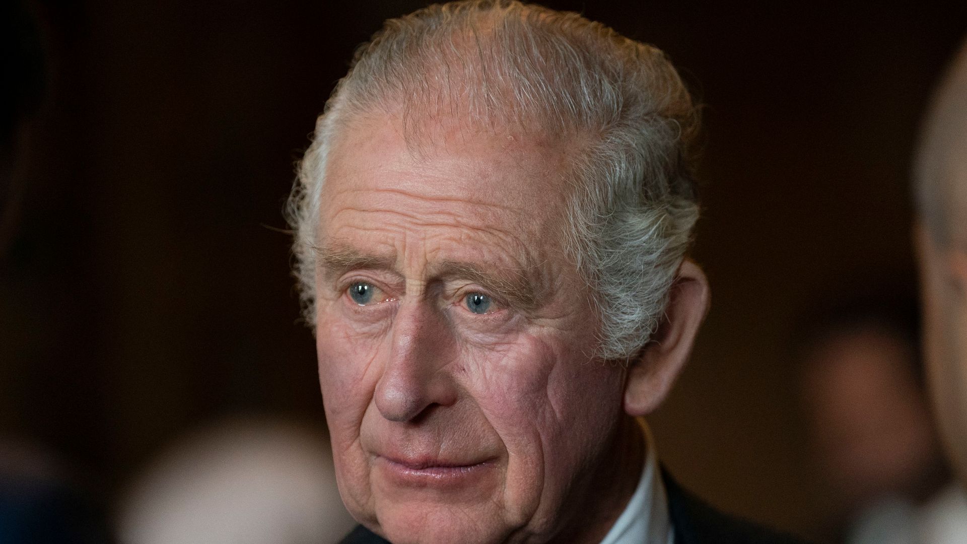 charles in black suit and tie