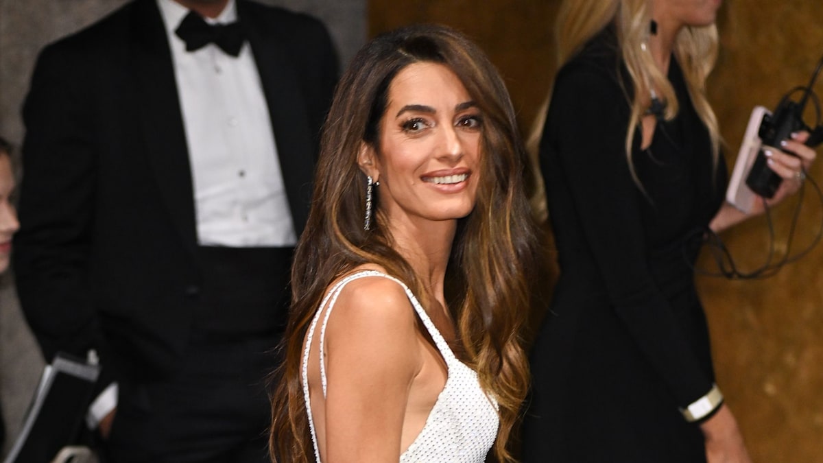 Amal Clooney's crisp white halter neck dress is pure perfection for scorching summer 2025