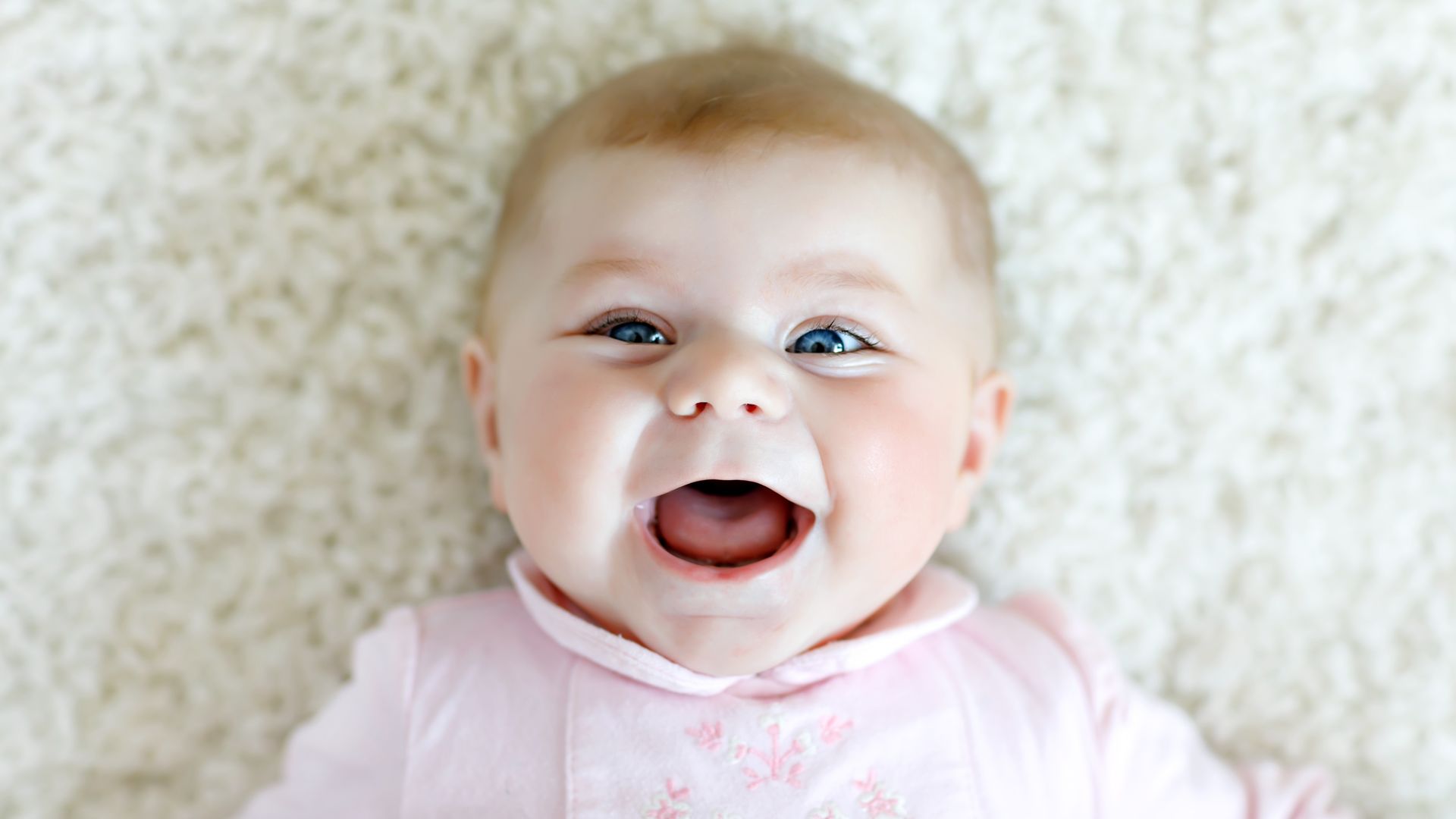 Close-up of a two or three months old baby girl with blue eyes