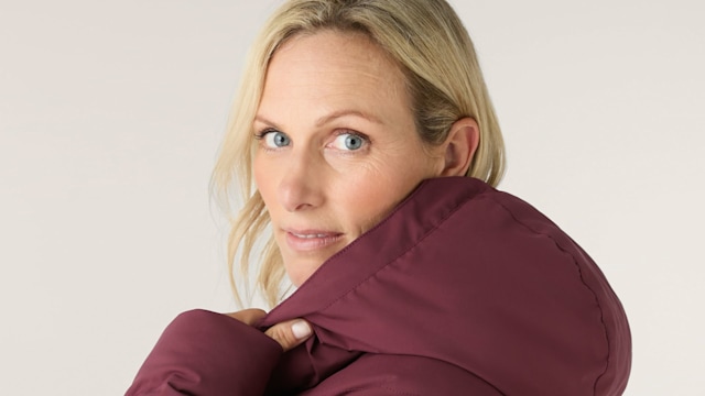 Zara Tindall wears a hooded burgundy jacket