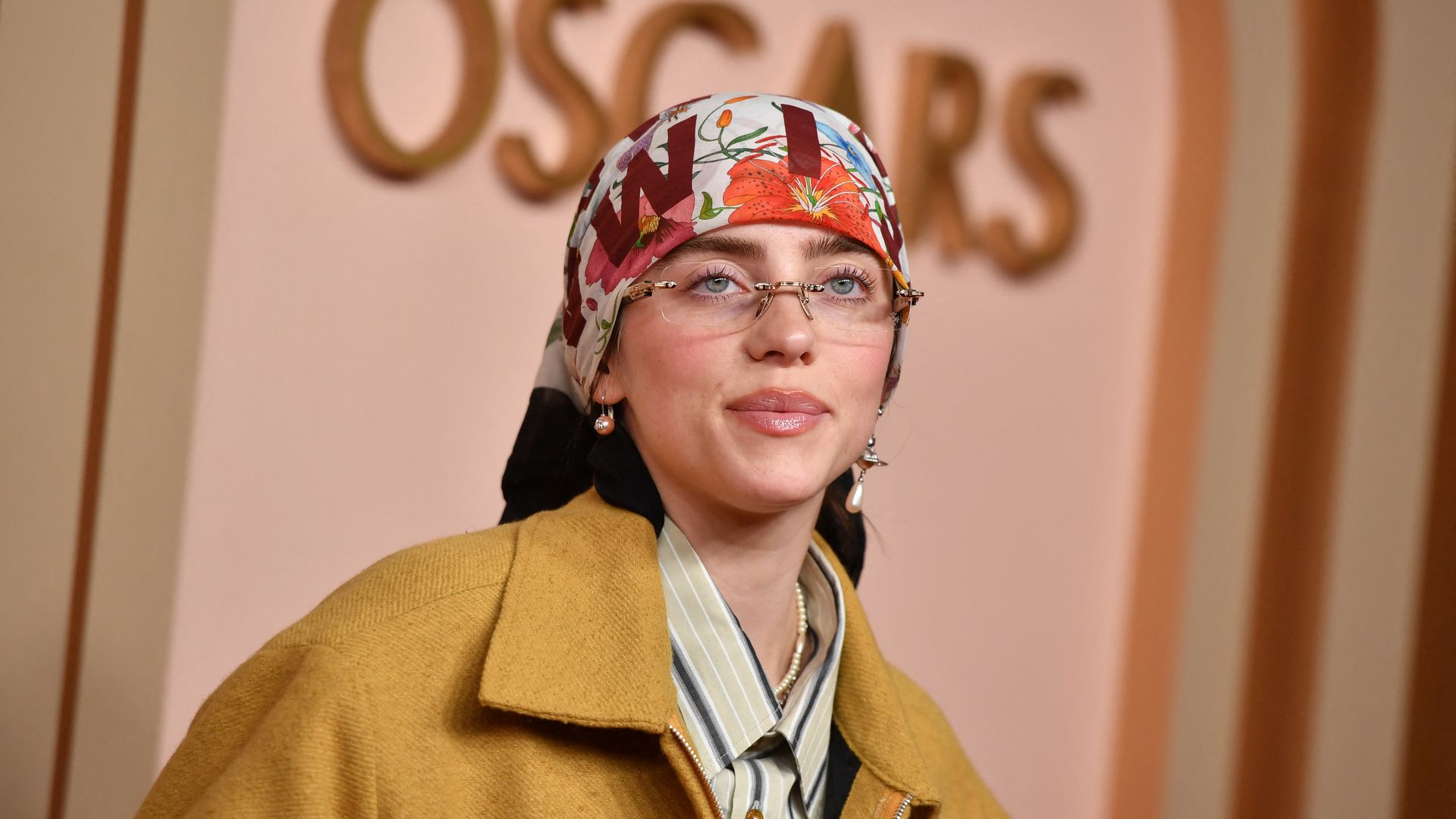 Billie Eilish wearing a headscarf and rimless glasses at the Oscars Luncheon