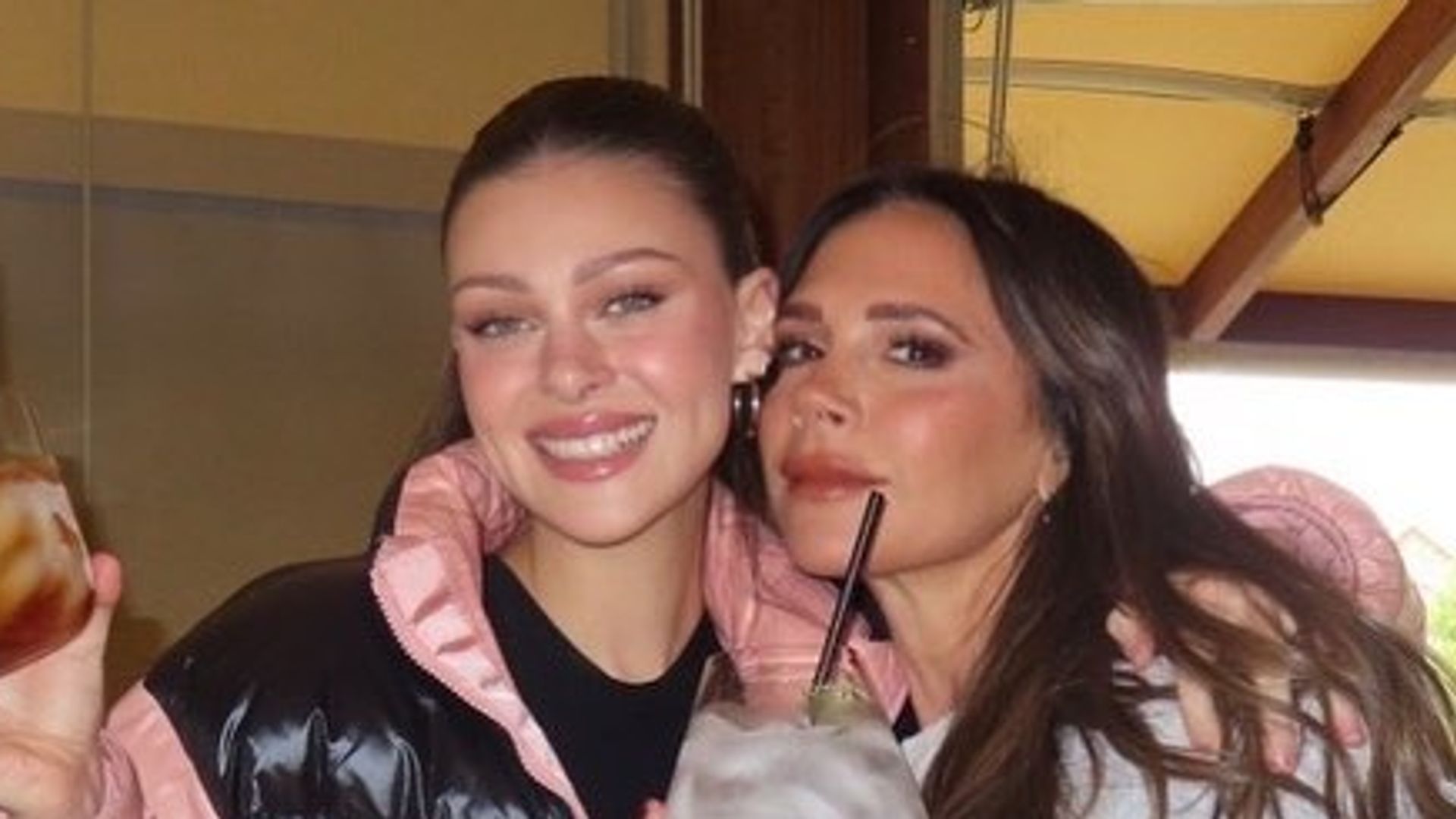 Victoria Beckham and Nicola Peltz drinking cocktails