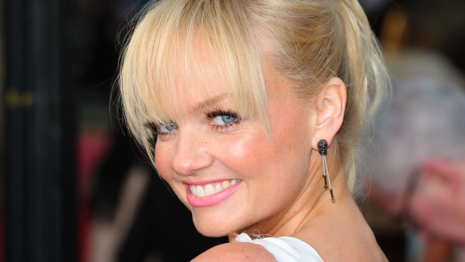 Emma Bunton looking over her shoulder in a white dress at the UK premiere of "Sex And The City 2" in 2010 