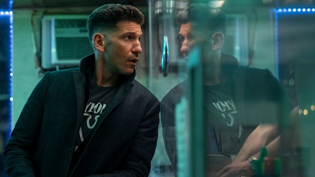 man leaning against glass window