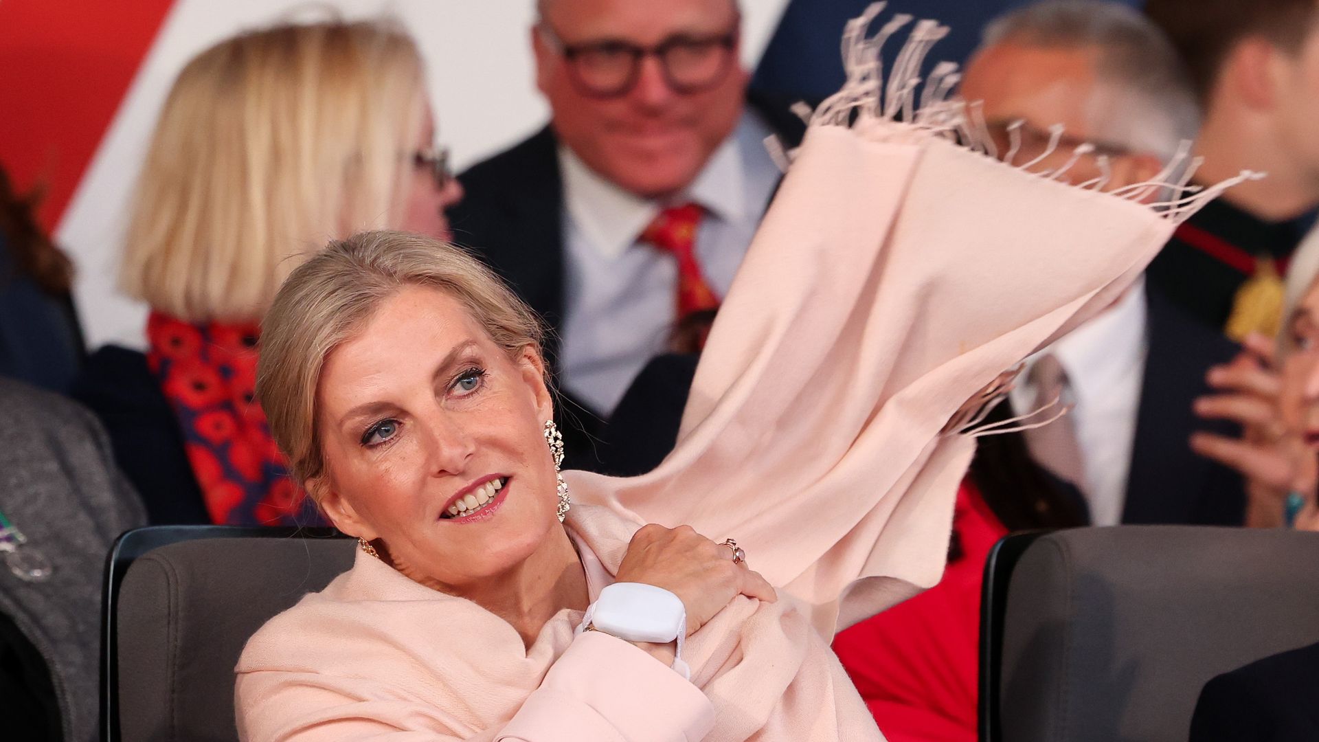 The Duchess of Edinburgh throwing a scarf behind her