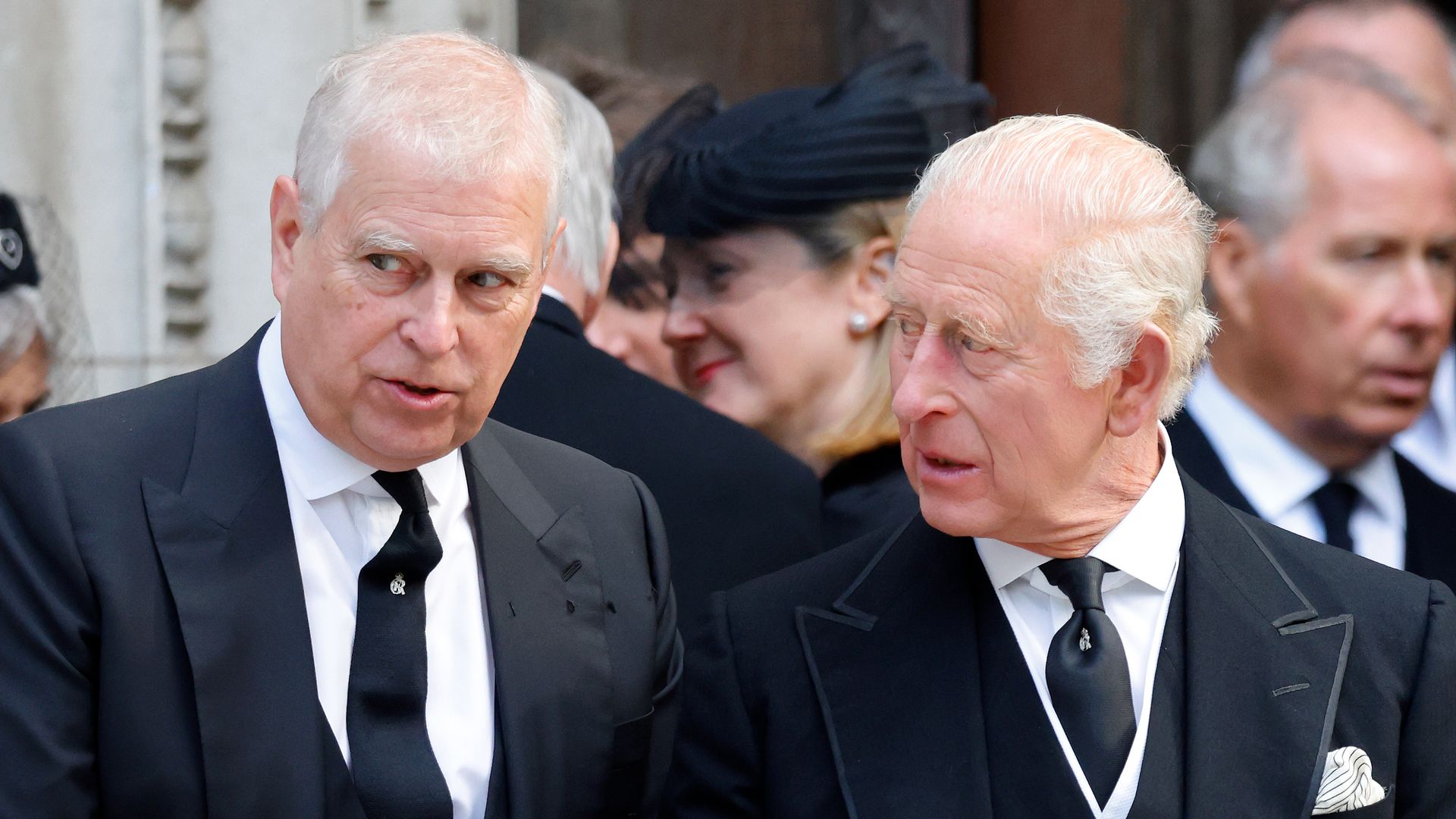 Prince Andrew speaking with King Charles at a funeral