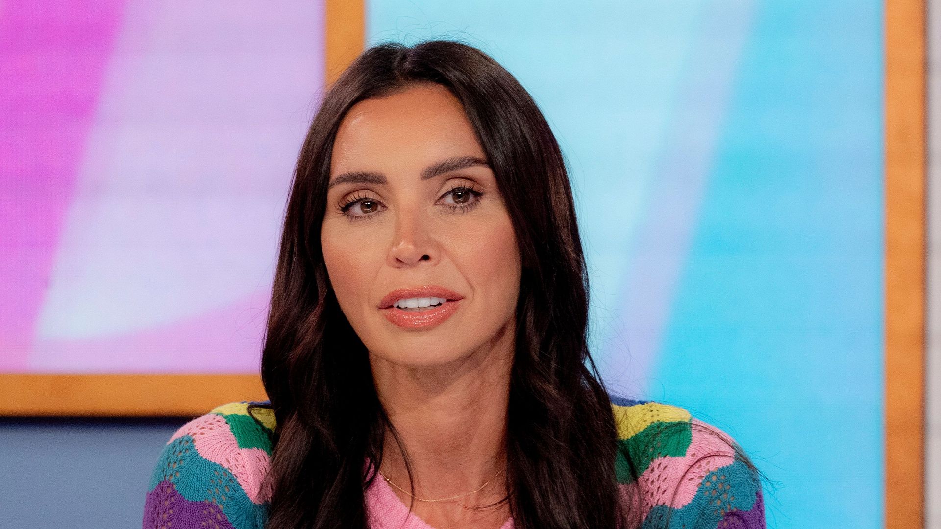 Christine Lampard wearing a colourful jumper and looking serious whilst presenting Loose Women
