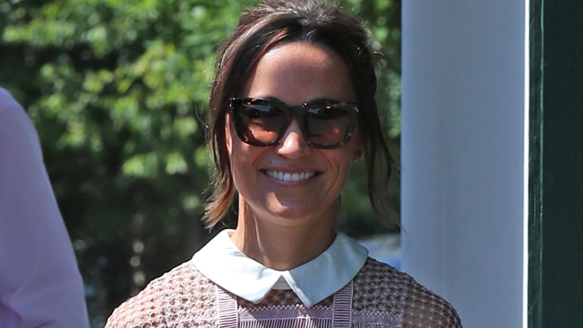 Pippa Middleton in a pink and white lace dress and sunglasses