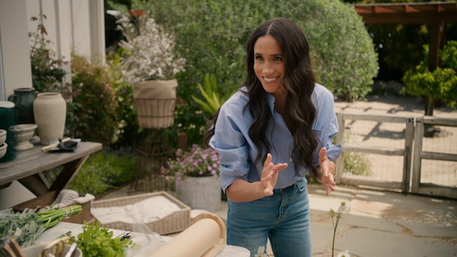 Meghan Markle dancing while arranging flowers