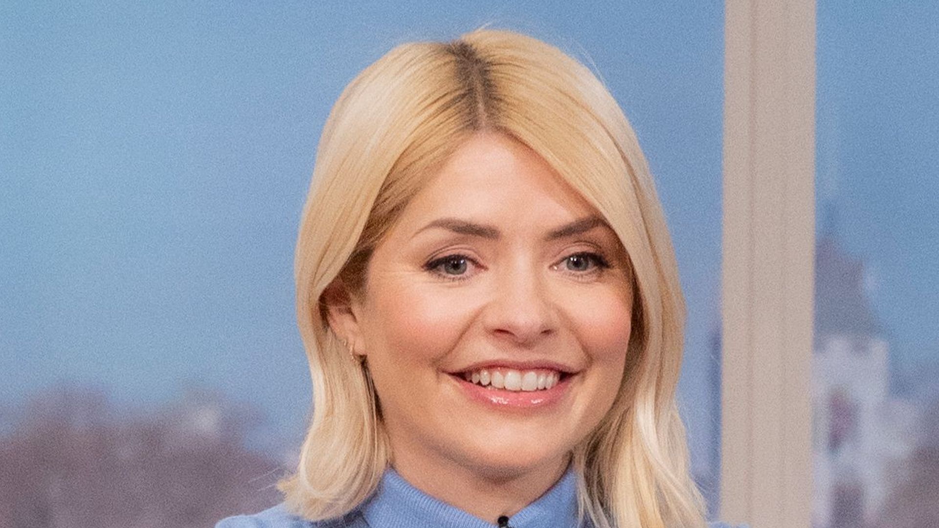 Holly Willoughby in a blue top and pink skirt on This Morning